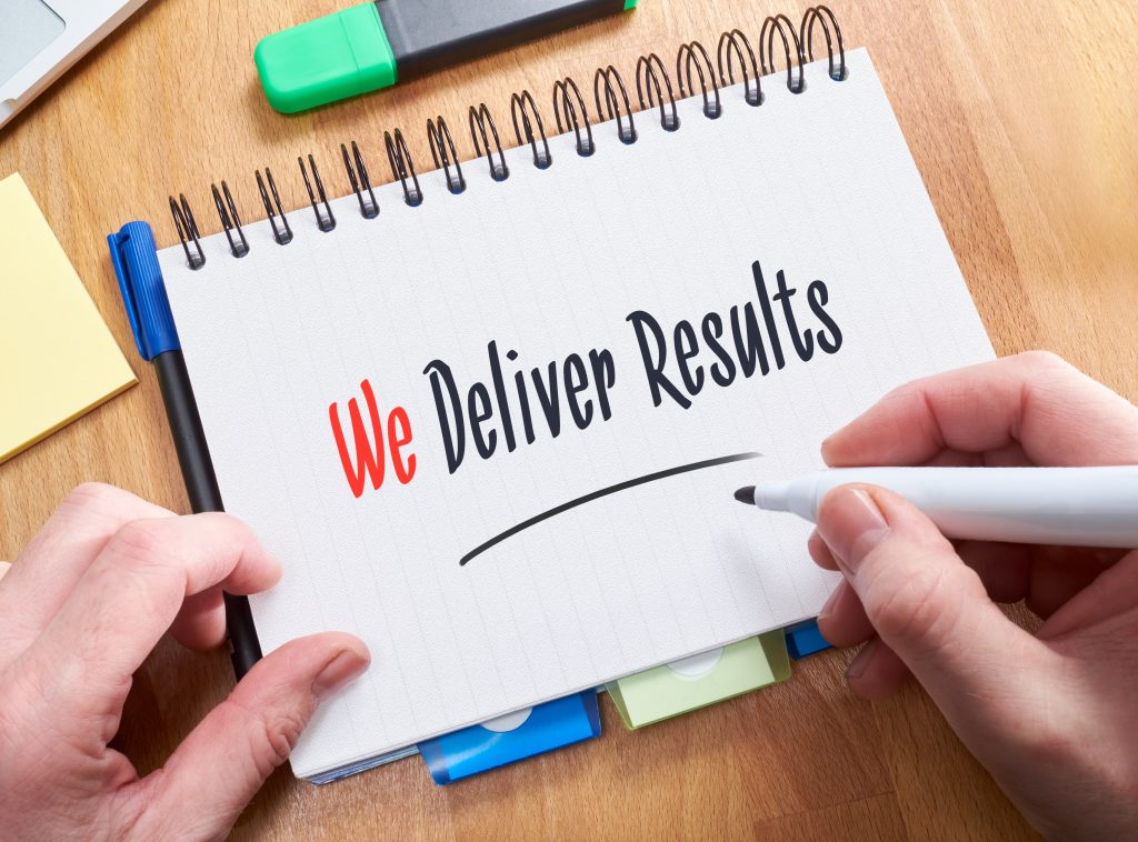 We Delivery Results written on a notepad